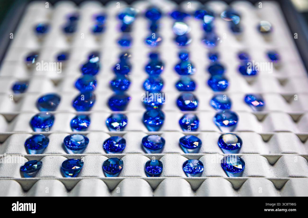 Faceted blue sapphire gemstones in various cuts fill display a tray in a jewelry workshop in the Grand Bazaar in Istanbul, Turkey, behind the scenes Stock Photo