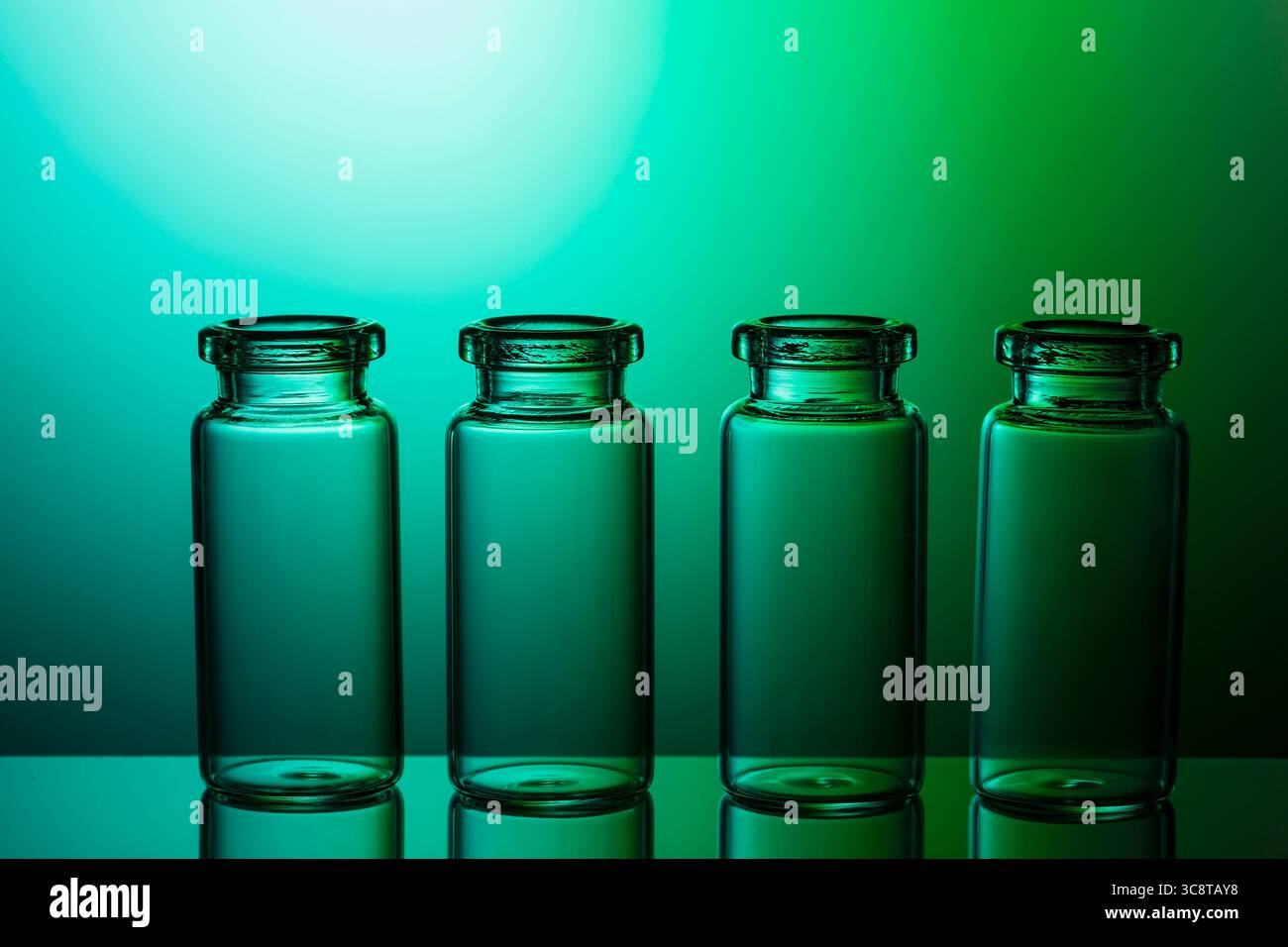 Empty little bottles on nice blue green gradient background. Stock Photo