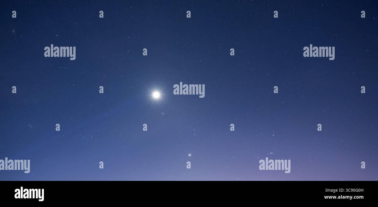 Captured from Sidemen at night, this astrophotograph juxtaposes the earthly solidity of Mount Agung with the sprawling infinity of the night sky. The Stock Photo
