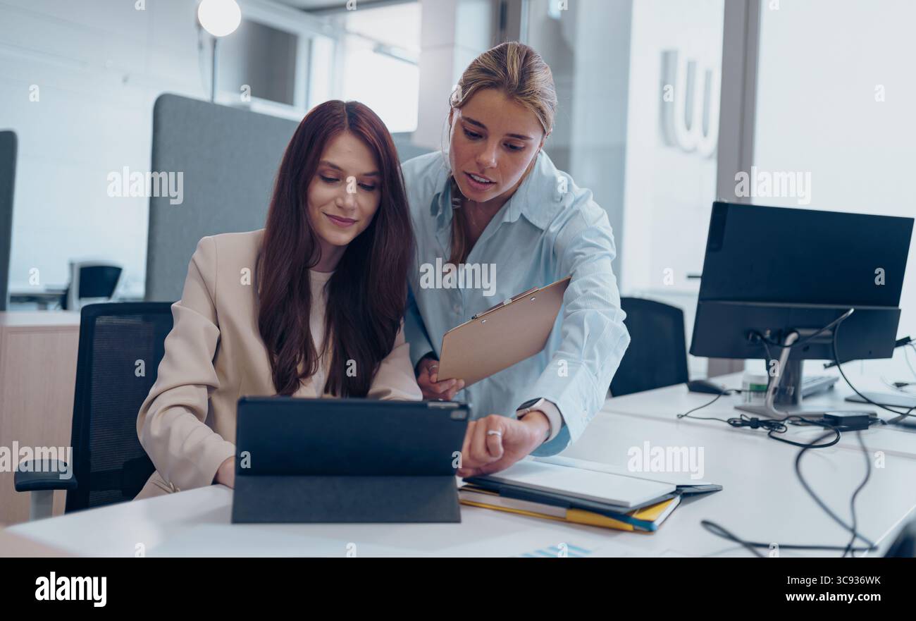 Engaging Collaborative Meeting in a Modern Office Setting with Technology Integration Stock Photo