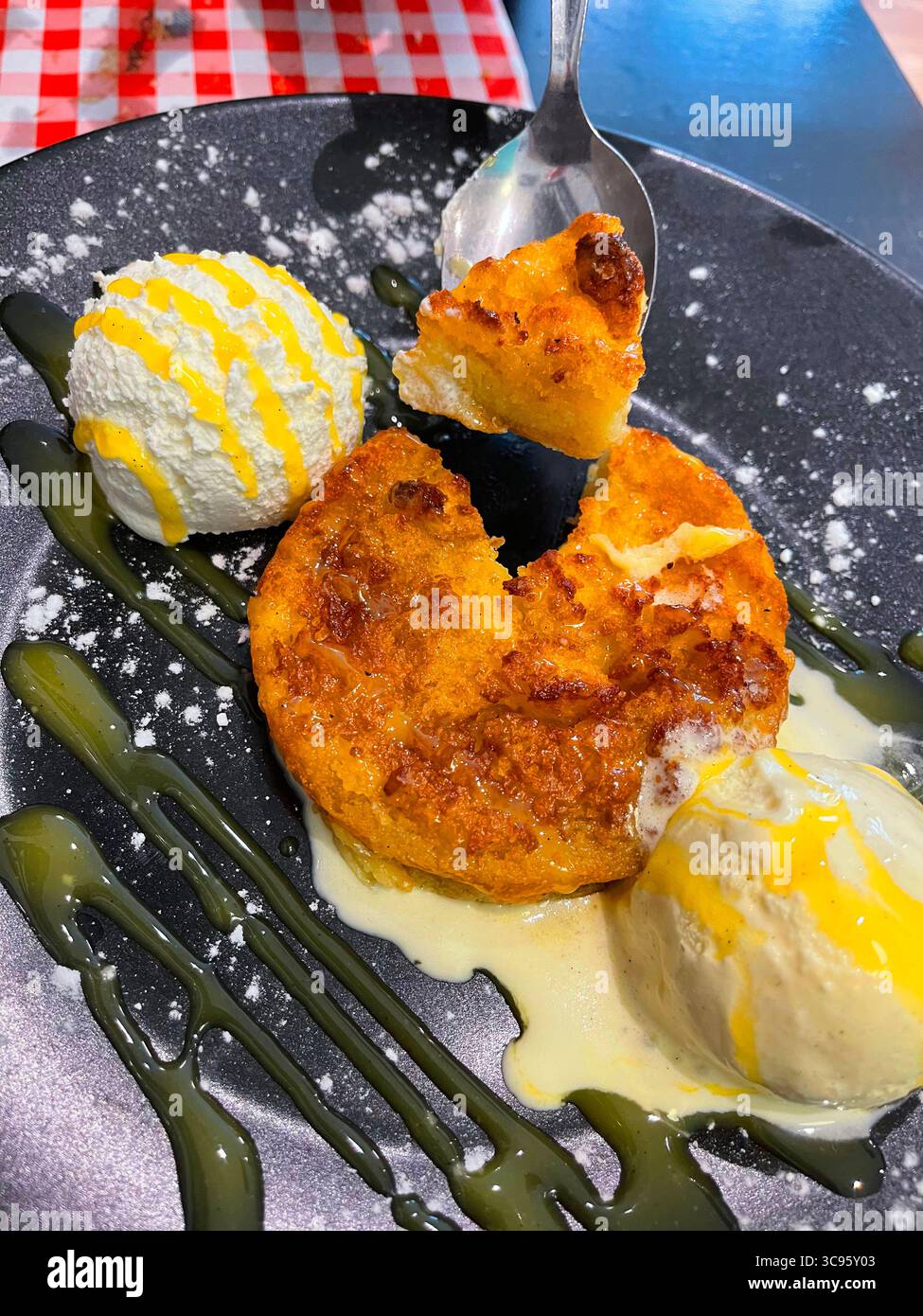 Eating torrija with ice cream, traditional Spanish Holy Week dessert. Spain. - Smartphone Captured Stock Image