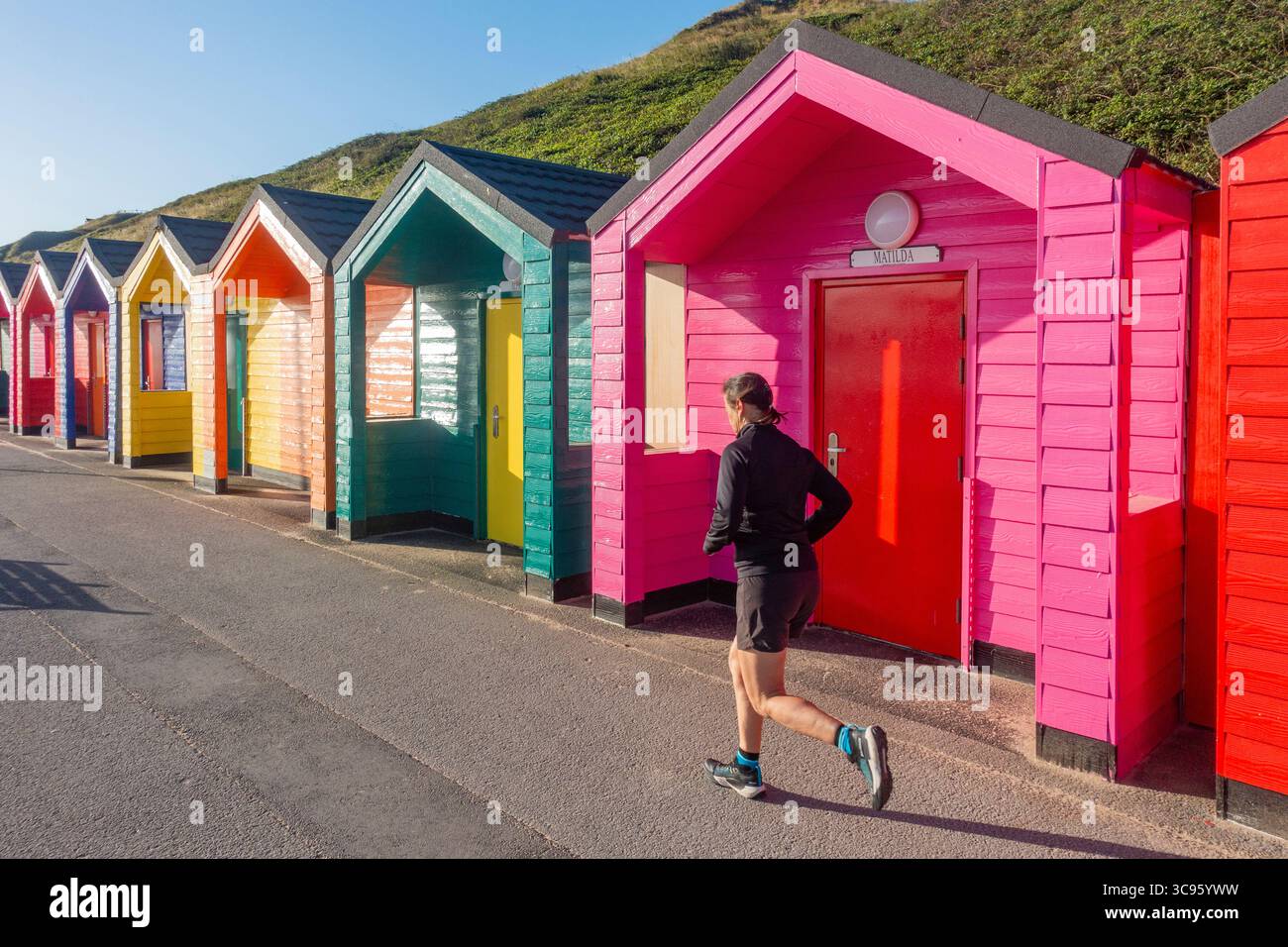 Middle aged woman jogging, running on beach Stock Photo