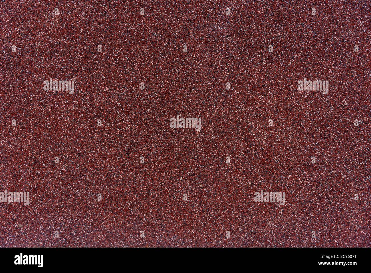 Red Texture Coating Close-up texture of red granular roofing surface with mineral coating ...