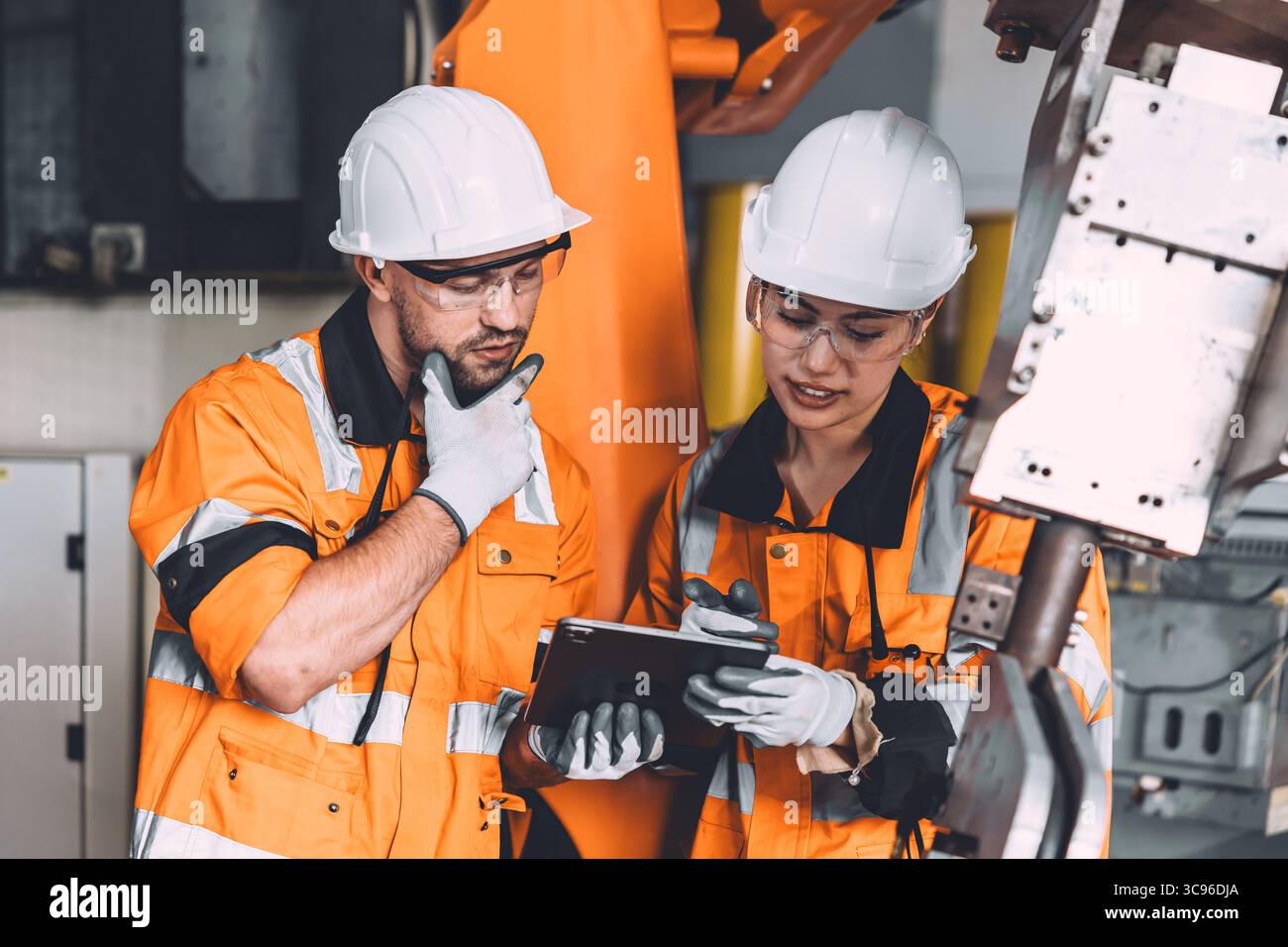 Engineer team service robot welding working in automation factory. People workers safety work control robot machine in heavy industry technology. Stock Photo