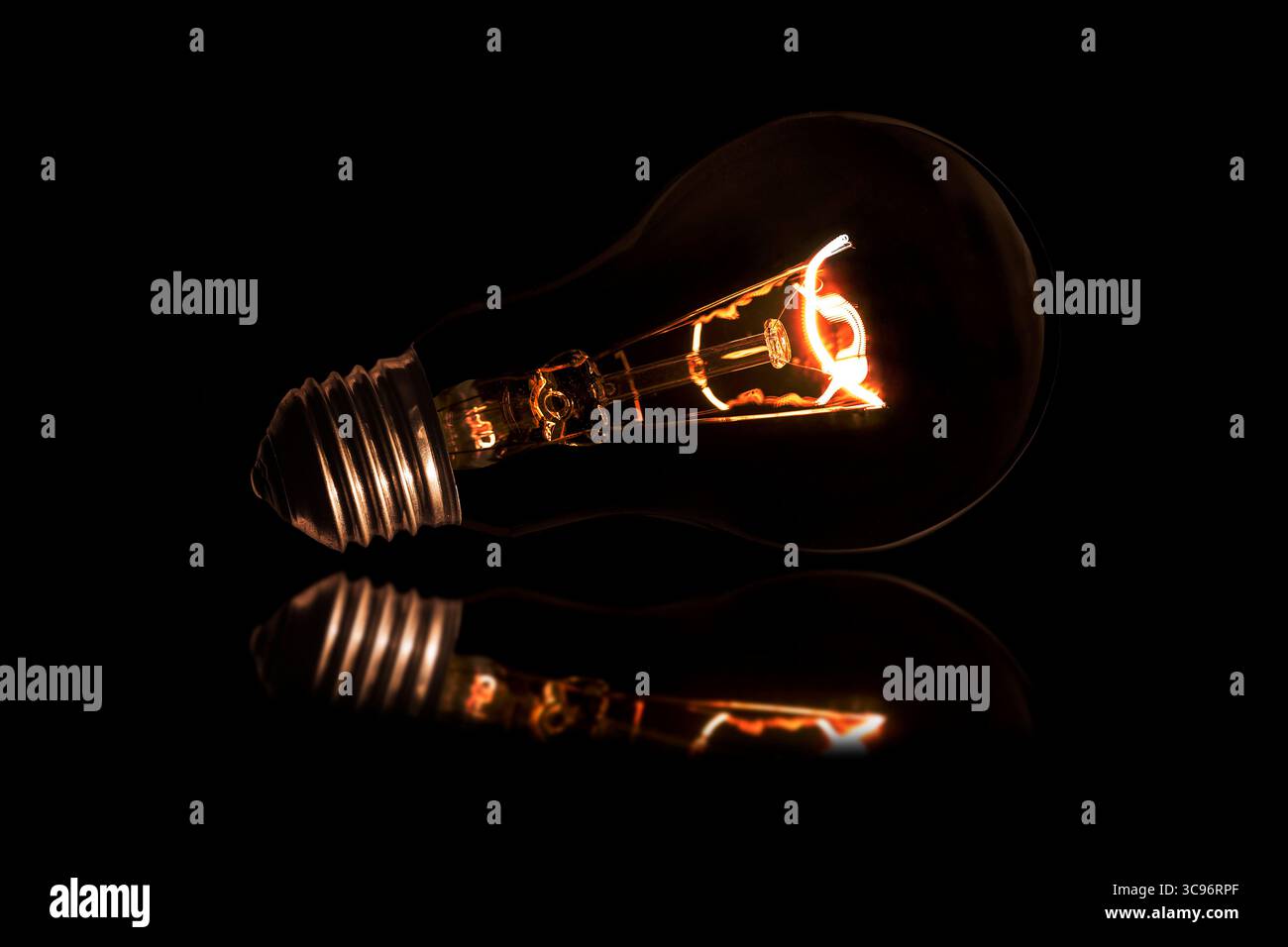 Glowing light bulb without wires on black background. Stock Photo