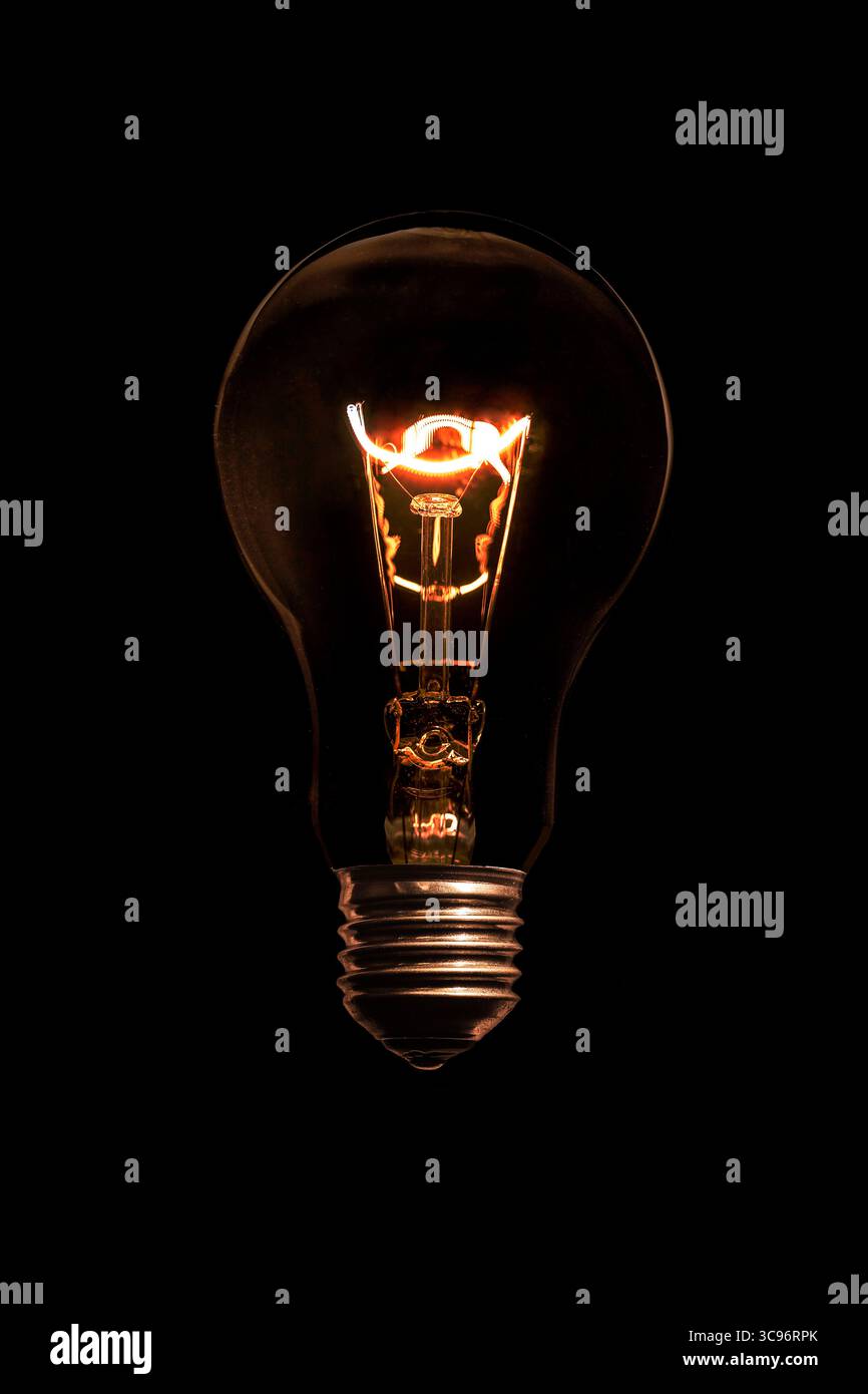Glowing light bulb without wires on black background. Stock Photo