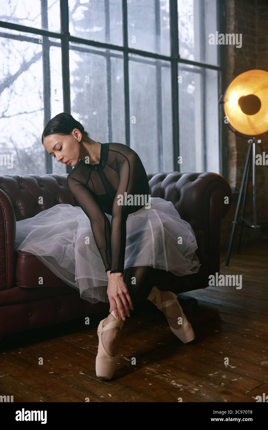 An elegant ballet dancer captured in a beautifully designed studio setting Stock Photo