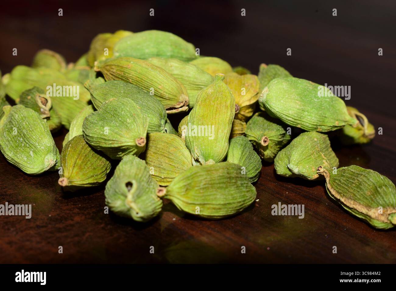 spice green cardamom (elettaria cardamomum) in a wooden background Stock Photo