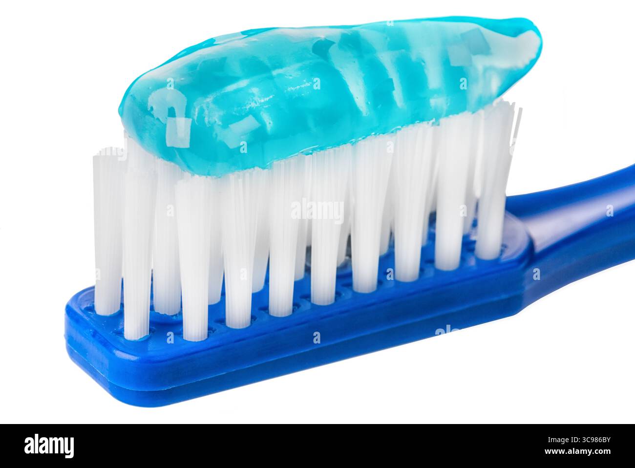 toothpaste on toothbrush extreme macro isolated on white background. Stock Photo