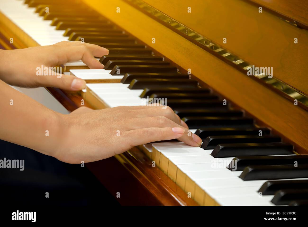 Man hands playing piano, close up. Stock Photo