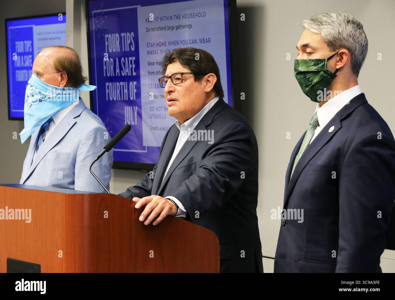 July 2, 2020, San Antonio, Texas, USA: George Hernandez, president and CEO of University Health System (center) speaks as Mayor Ron Nirenberg (right) and Bexar County Judge Nelson Wolff (left) join the leaders of the county's four hospital systems as they give a press conference on the stress levels local hospitals are undergoing as a result of the surge of COVID-19 cases and hospitalizations. They are all urging people to avoid large gatherings during the 4th of July holiday weekend. (Credit Image: © Kin Man Hui/San Antonio Express-News via ZUMA Press Wire) Stock Photo