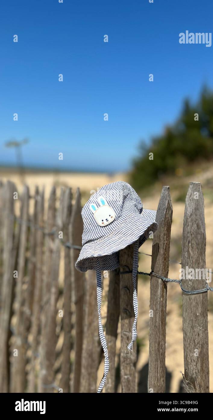 Kids sunhat on a fence - Smartphone Captured Stock Image