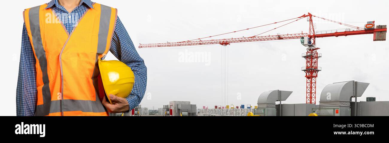 Engineer standing with Industrial construction crane on background. (With Clipping path) Stock Photo