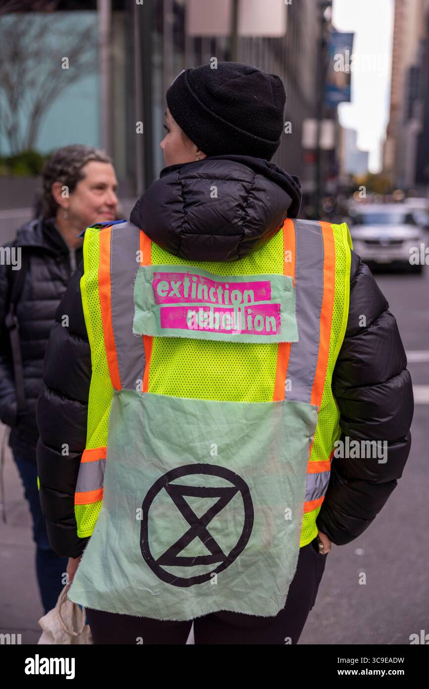 October 28, 2022, New York, New York, USA: A demonstrator wears an the Extinction Rebellion symbol. Climate activists erected 20 foot high tripods and blocked traffic on Park Ave outside of JP Morgan Chase Headquarters. Protesters target the bank for itâ€™s funding of fossil fuels and call on Governor Hochul to tax the rich for green housing for all in NYC. The action was organized by climate activists with Extinction Rebellion NY, Sunrise Movement NY and New York Communities For Change, one of a series of Occupy Park Ave protests marking the tenth anniversary of Hurricane Sandy. (Credit Image Stock Photo
