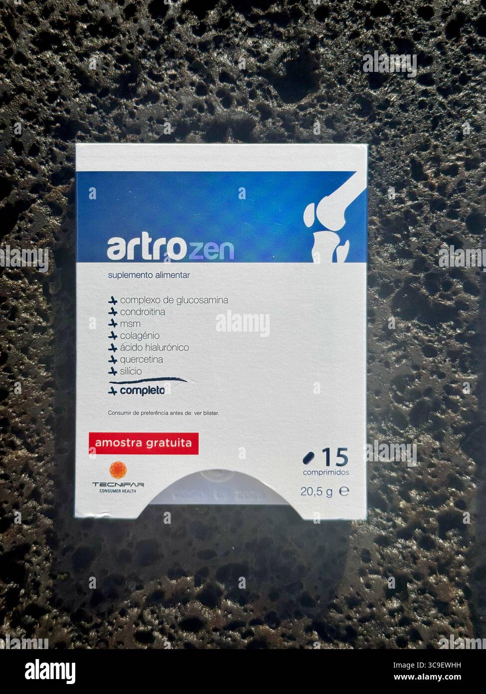 ArtroZen dietary supplement boxes displayed on green grass in natural outdoor light. - Smartphone Captured Stock Image