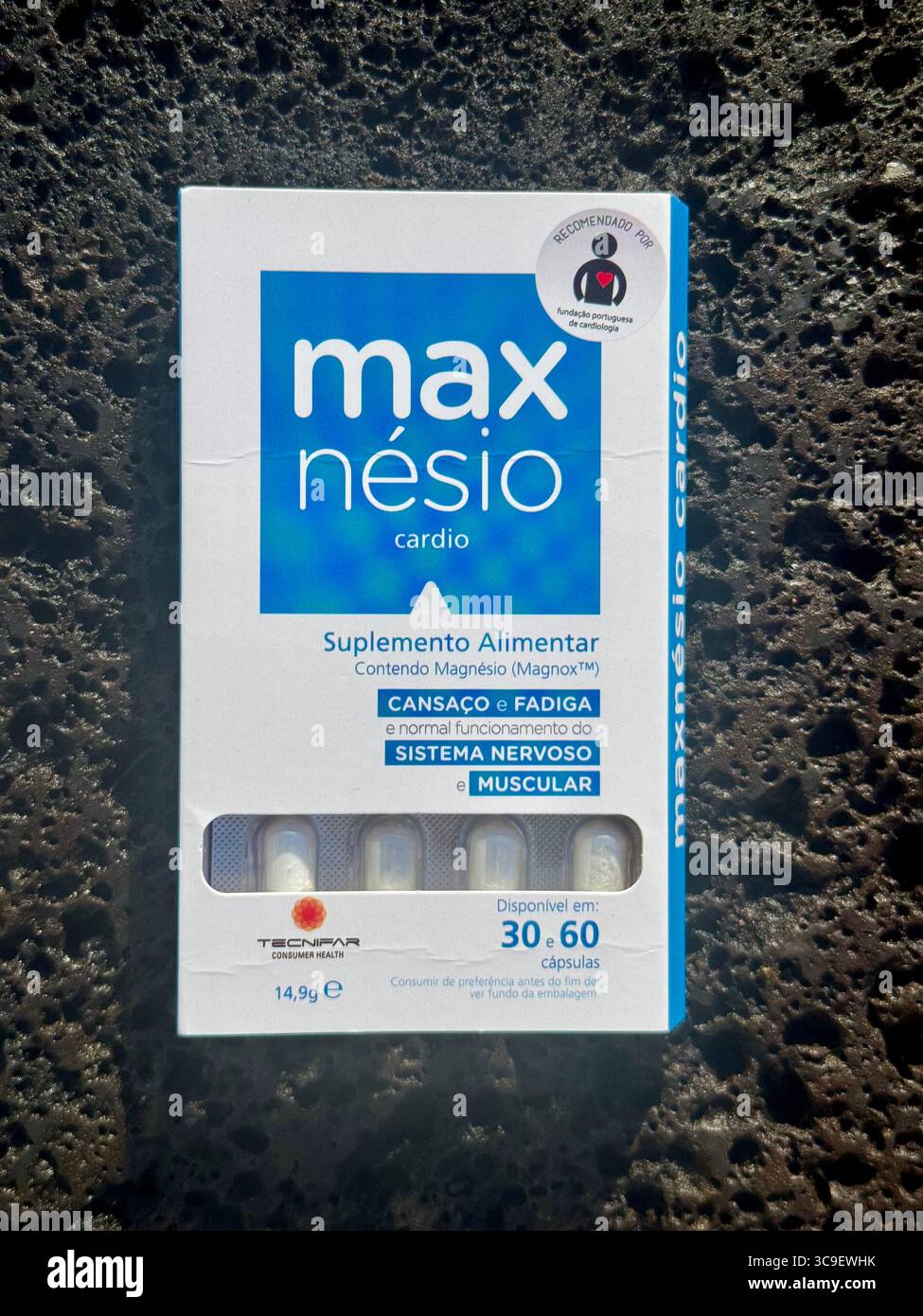 Boxes of Maxnésio dietary supplement displayed on a flat surface in natural daylight. - Smartphone Captured Stock Image