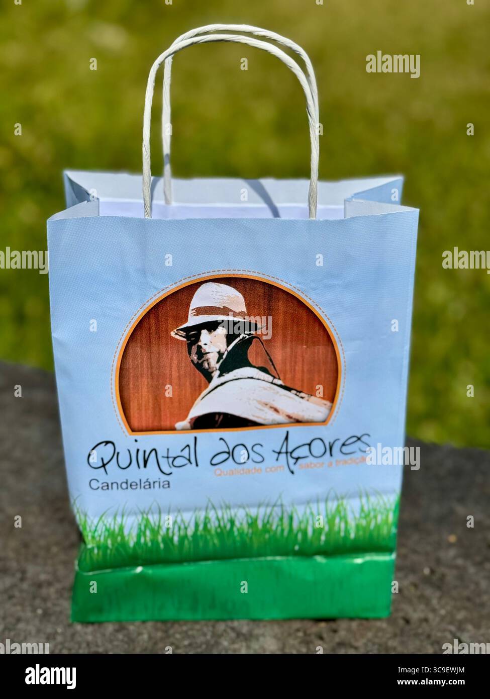 Branded gift bag from Quintal dos Açores, a traditional Azorean producer of jams and artisanal goods, photographed outdoors. - Smartphone Captured Stock Image