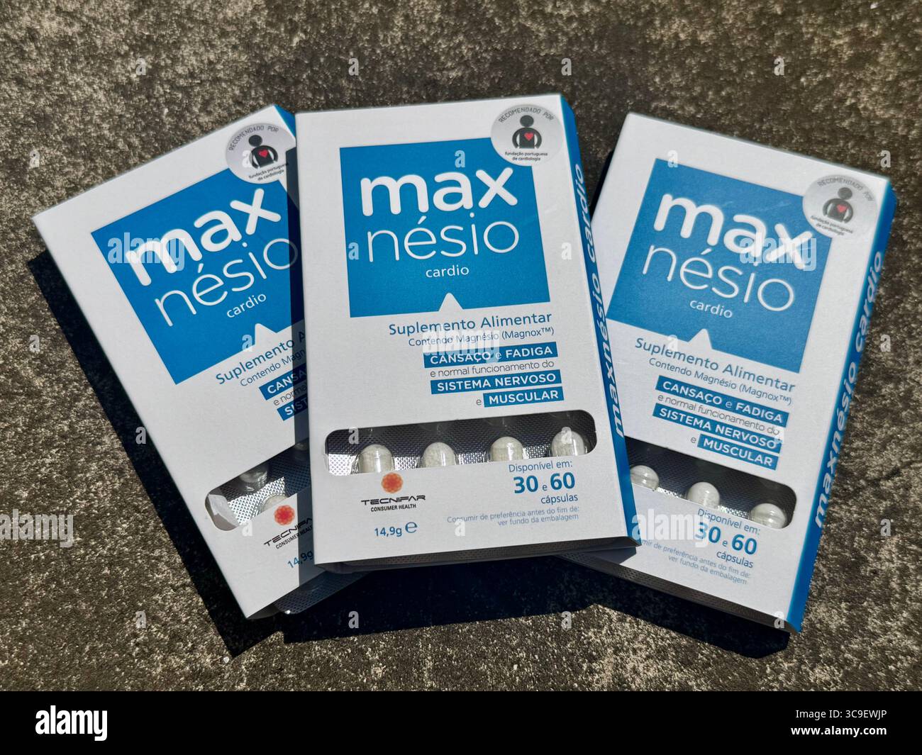 Boxes of Maxnésio dietary supplement displayed on a flat surface in natural daylight. - Smartphone Captured Stock Image