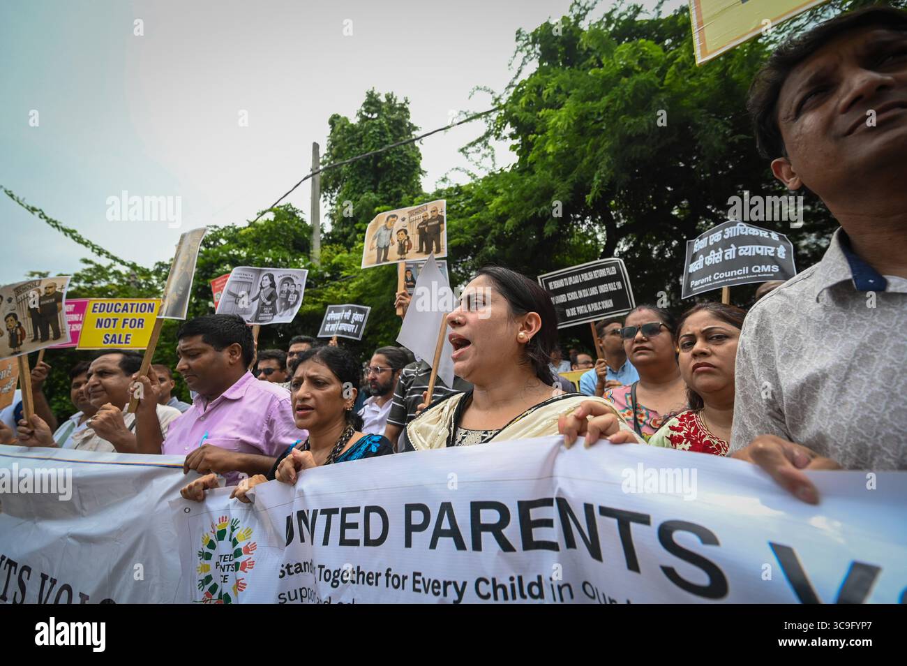 NEW DELHI, INDIA - AUGUST 5: Parents under the banner from United ...