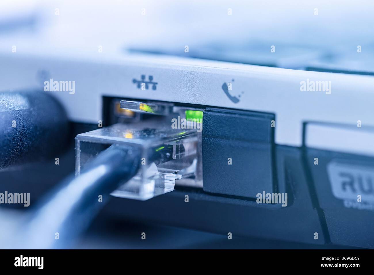 LAN network cable connected to RJ-45 port notebook close up. Stock Photo
