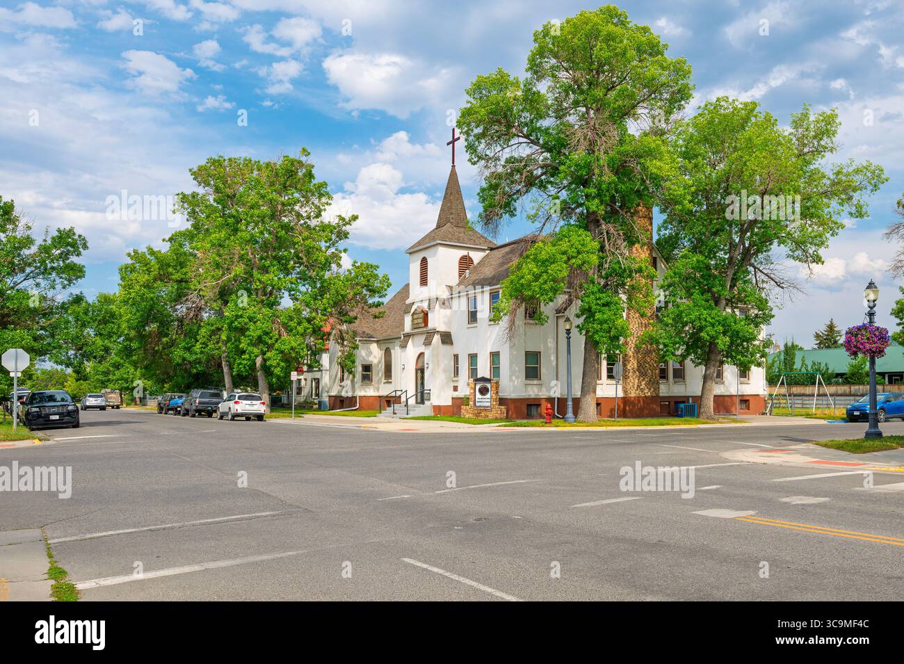 A picturesque corner connecting the residential district to the historic old town with a corner church in  the small town of Livingston, Montana. Stock Photo
