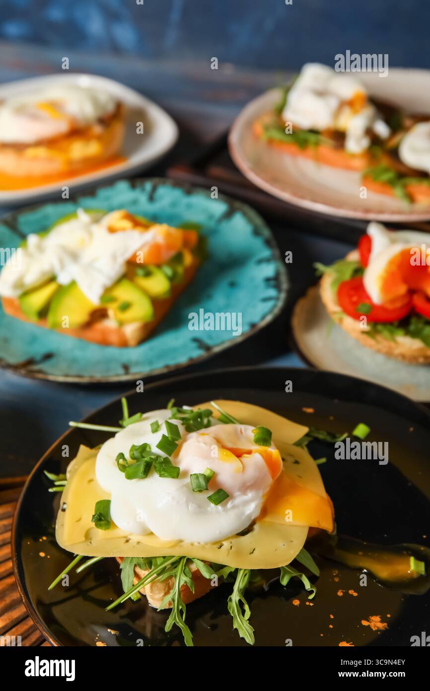 Plates with tasty eggs Benedict on table Stock Photo