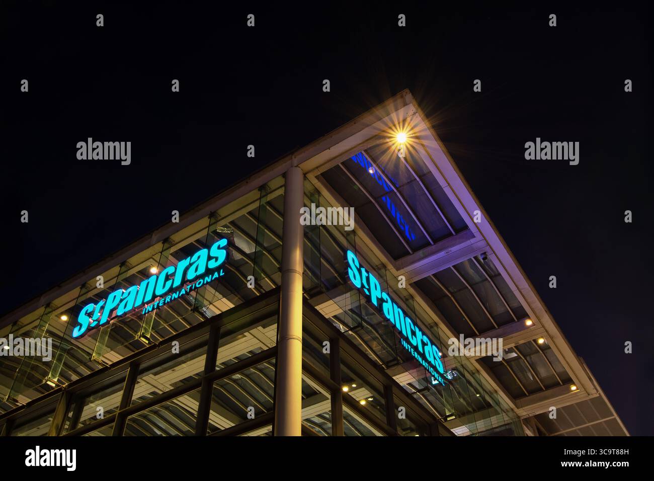 Atmospheric elevated view of St Pancras International train station sign designed by Dalton Maag with copyspace. London, England, UK. Night scenes. Stock Photo
