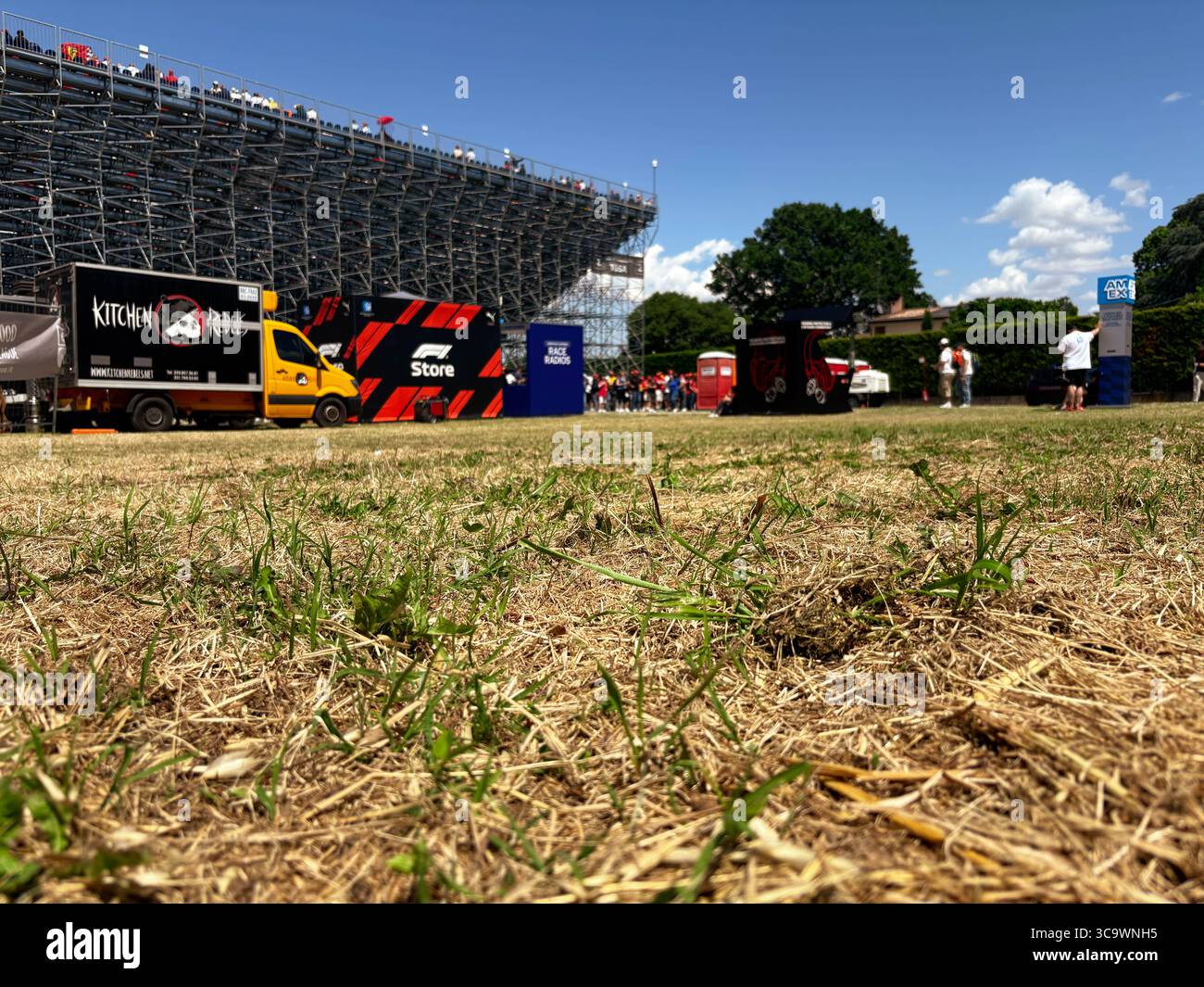 IMOLA, ITALY - May 18, 2025: Tosa 2 fans stand, view from below. Stand with fans before the start of the main race. Ferrari flag. Stock Photo