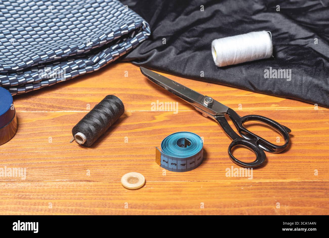 Sewing stuff - thimble, thread, scissors, needle, button, meter, on a wooden table Stock Photo