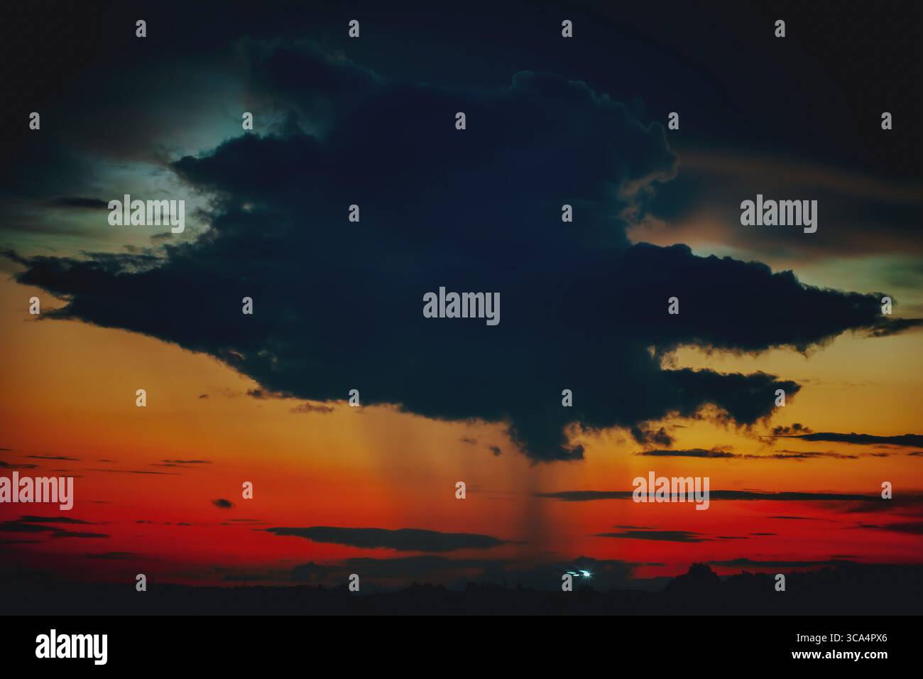 Dark thundercloud cell and rain at sunset Stock Photo