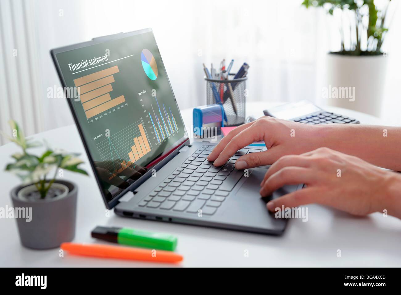 Man using 2 in 1 laptop to financial data analysis. Analyst at work. Stock Photo