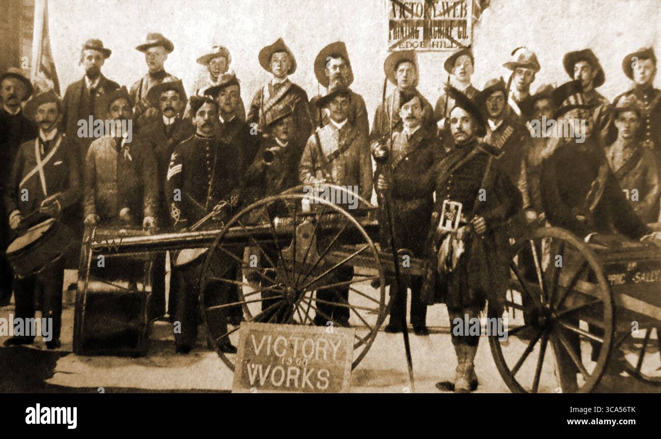 Relief of Mafeking - British Boer War soldiers pose during celebrations in Liverpool UK with a guy ( an effigy) of Kruger (Paul Kruger, the last president of the South African Republic - Transvaal) in a cart for  for burning.  the notice behind reads 'Victory Web ,  Printing Machine Co., Edgehill' Stock Photo