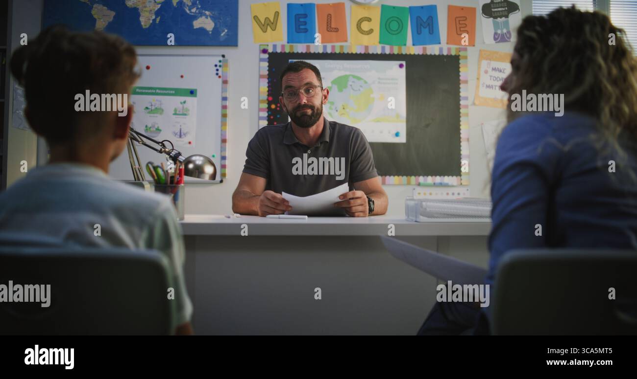 Male Teacher Giving School Test Results of Elementary School Child to ...