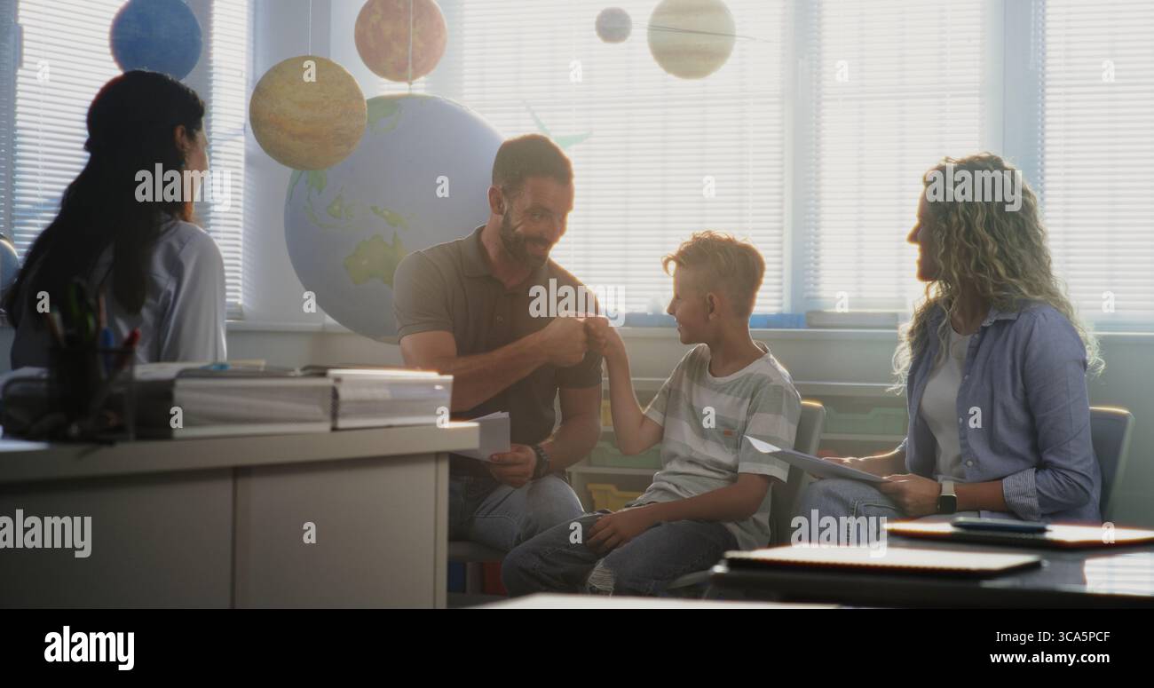Mother and Father Looking at School Test Grades of Their Son During ...