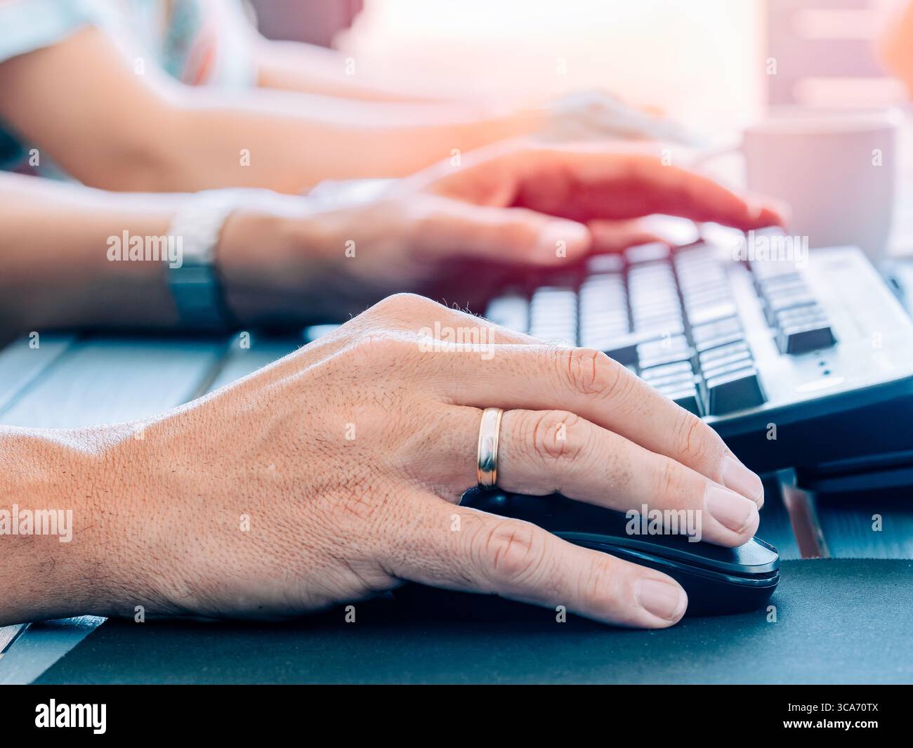 Close-up of teamwork on desktop computers Stock Photo