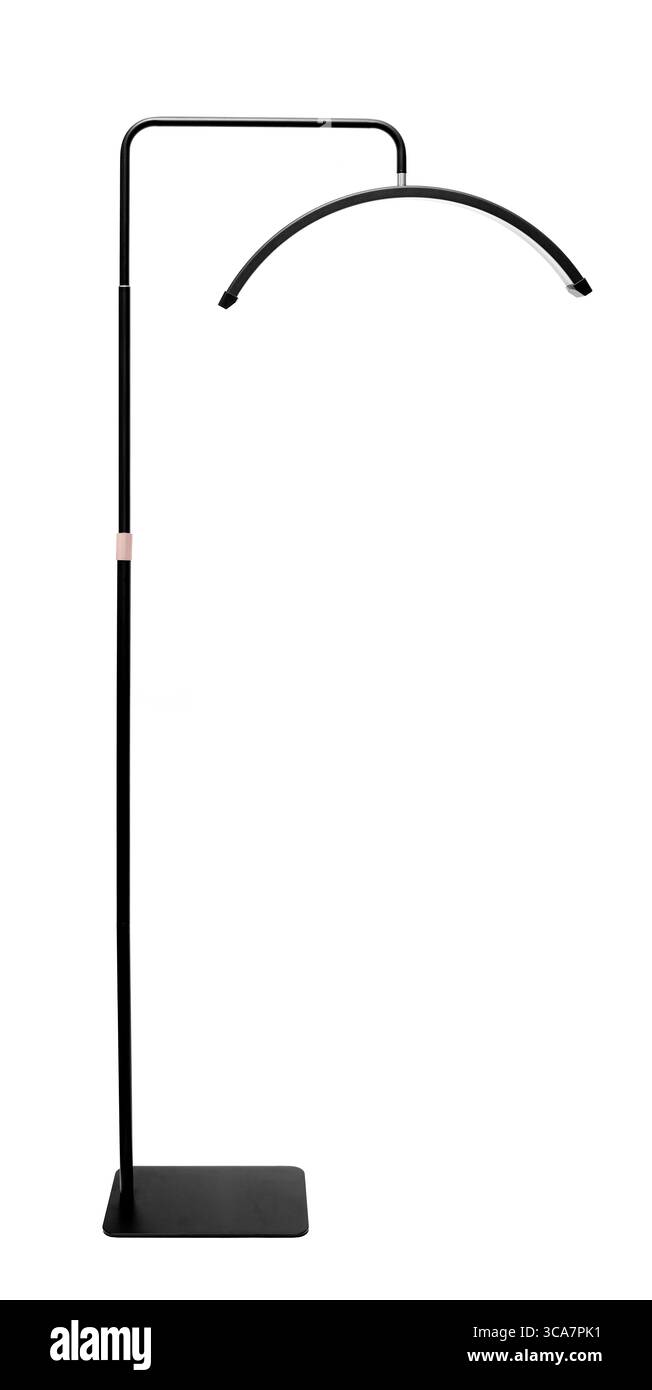 A modern black floor lamp with a curved head and a rectangular base on white. Stock Photo