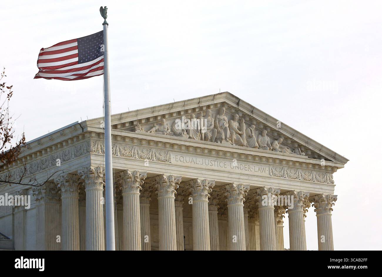 March 13, 2023, WASHINGTON, D.C, WASHINGTON, D.C, USA: The American flag flies over the Supreme Court In Washington, D.C. on March 13, 2023.  The Supreme Court has asked Congress for about $12.4 million in additional funding to better protect the justices and the court building following threats. (Credit Image: © Stephen Shaver/ZUMA Press Wire) Stock Photo