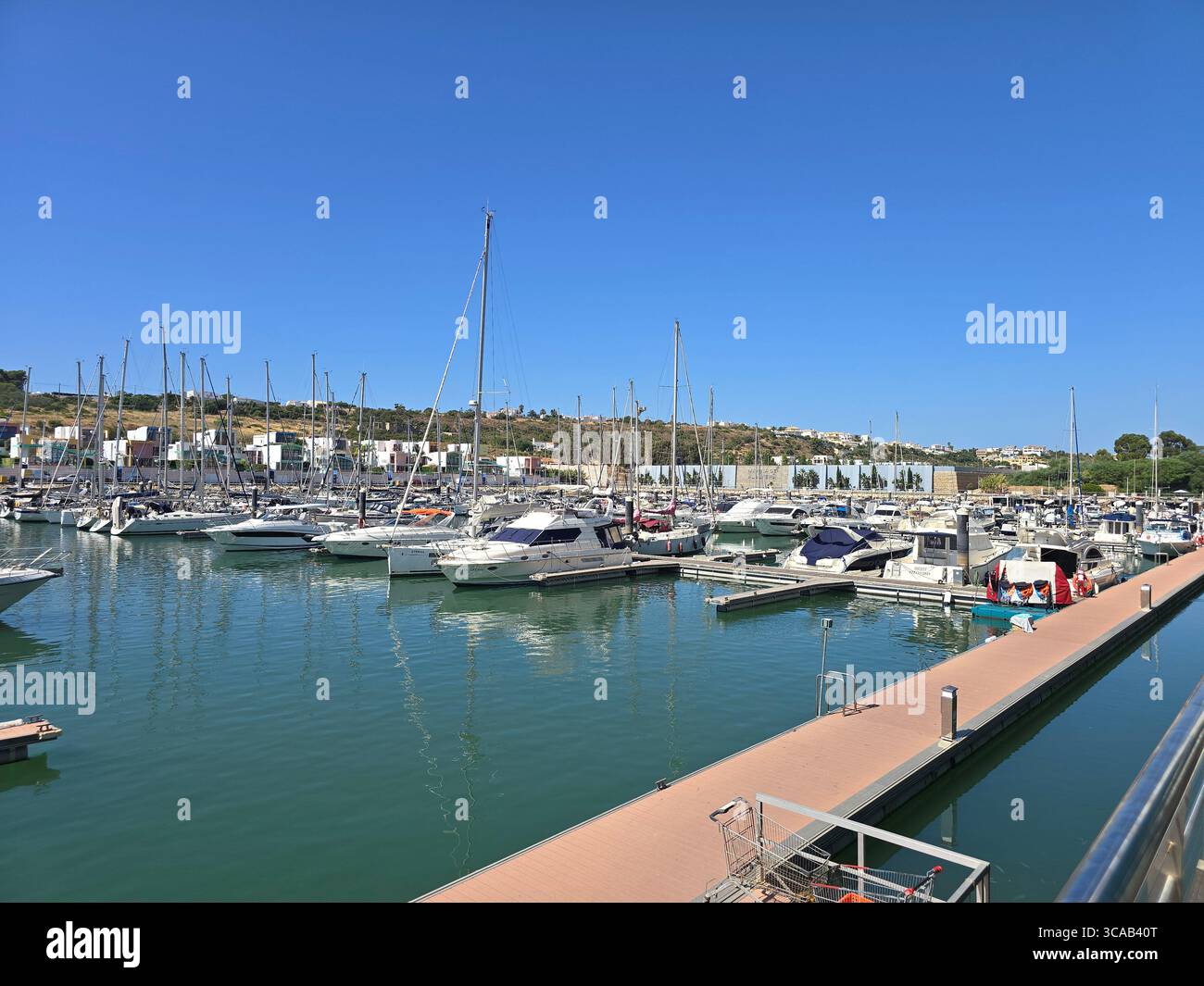 Albufeira Marina in the Algarve, Portugal, with yachts and sailboats docked on a sunny day. - Smartphone Captured Stock Image