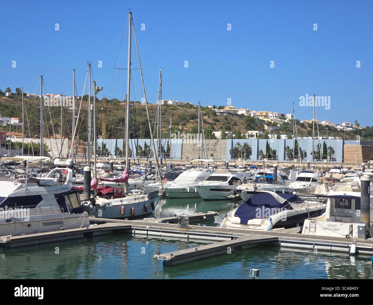 Albufeira Marina in the Algarve, Portugal, with yachts and sailboats docked on a sunny day. - Smartphone Captured Stock Image
