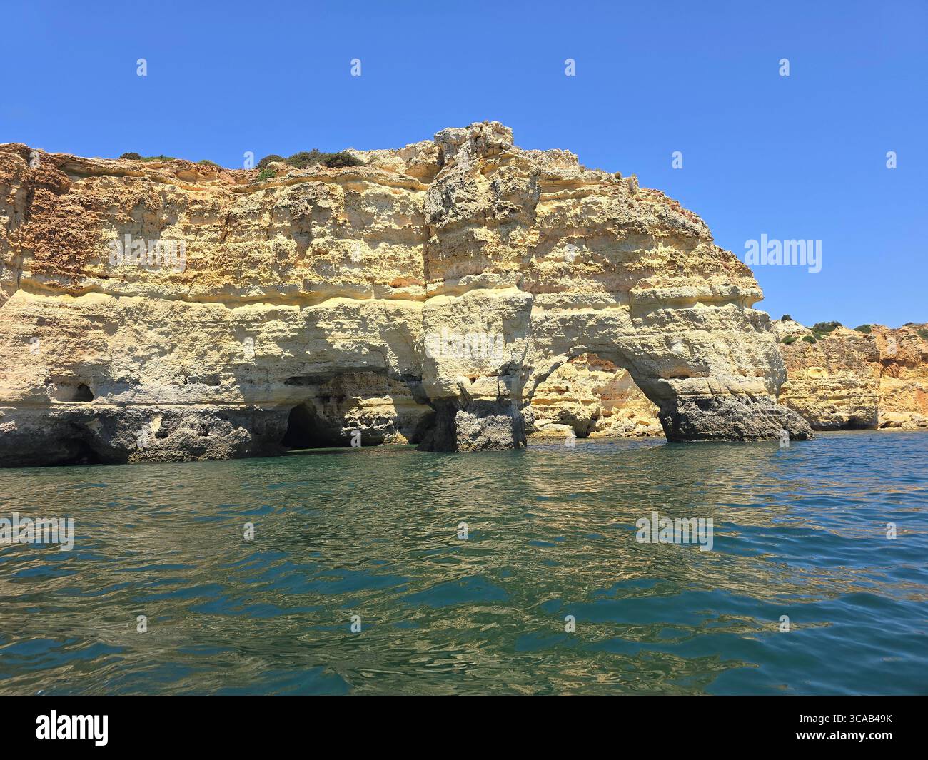 Limestone cliffs and scenic beaches along the Algarve coastline in southern Portugal, with rock formations, caves, and turquoise waters on a sunny day. - Smartphone Captured Stock Image Limestone cliffs and scenic beaches along the Algarve coastline in southern Portugal, with rock formations, caves, and turquoise waters on a sunny day. - Smartphone Captured Stock Image