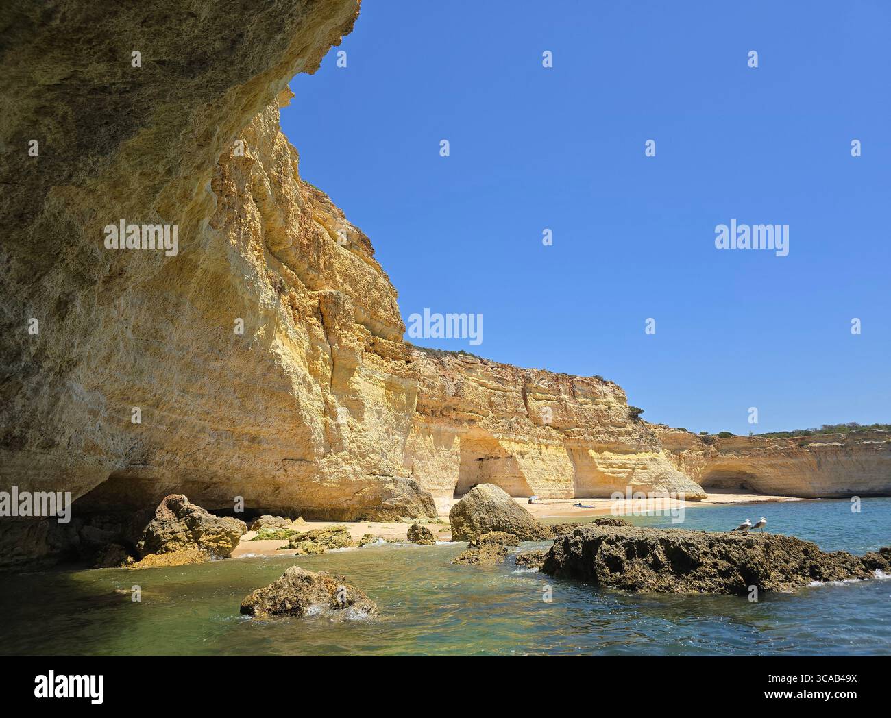 Limestone cliffs and scenic beaches along the Algarve coastline in southern Portugal, with rock formations, caves, and turquoise waters on a sunny day. - Smartphone Captured Stock Image Limestone cliffs and scenic beaches along the Algarve coastline in southern Portugal, with rock formations, caves, and turquoise waters on a sunny day. - Smartphone Captured Stock Image