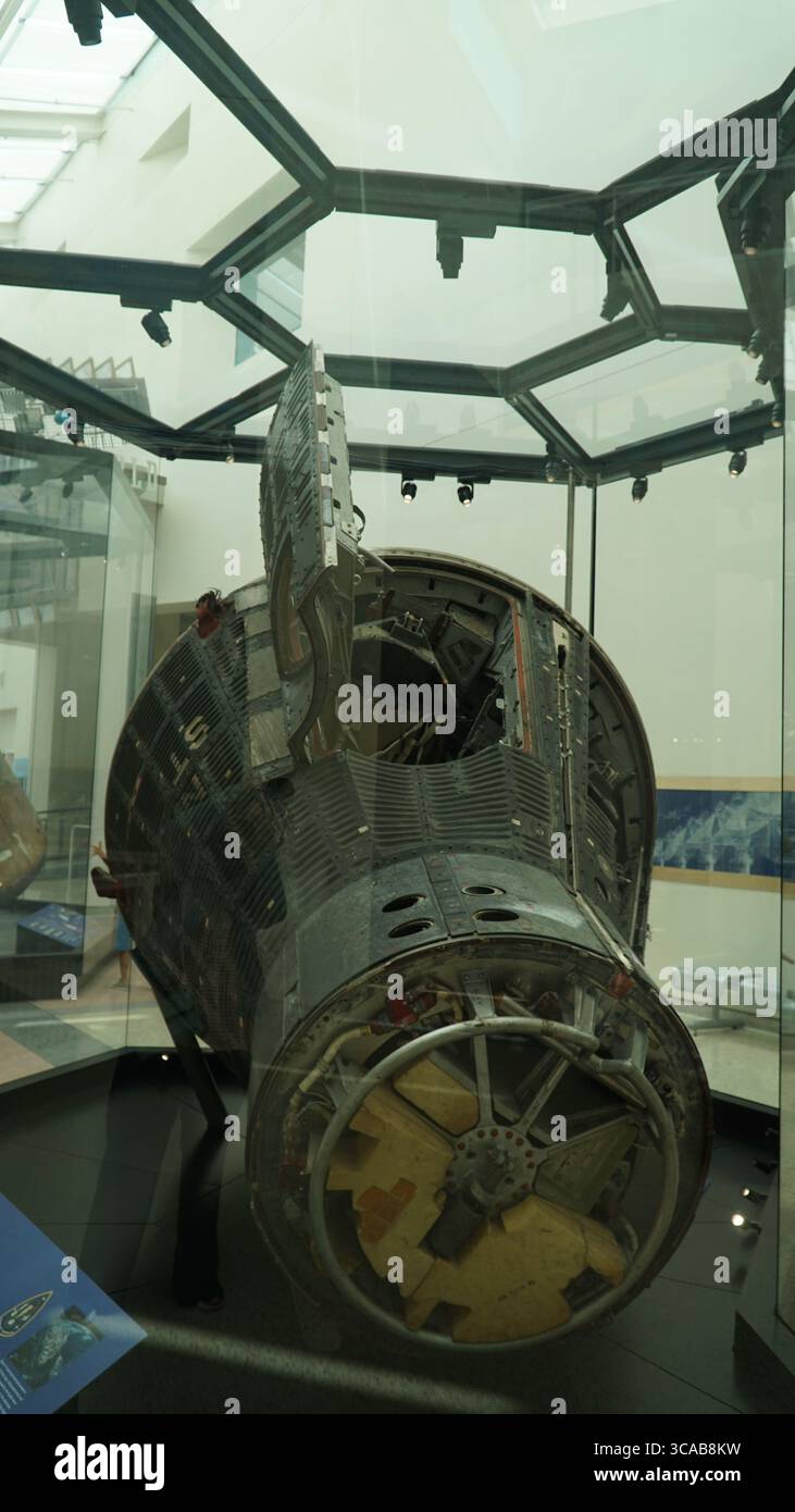 Close-up and full view of an original NASA Gemini spacecraft capsule displayed in a glass exhibit at the California Science Center, showcasing detaile Stock Photo