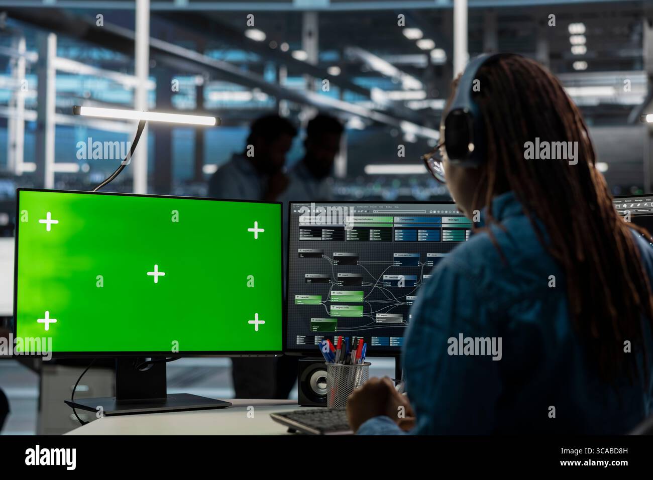 System administrator in server farm using isolated screen PC to repair equipment storing datasets. IT expert using chroma key computer to do debugging on rigs doing computational operations Stock Photo