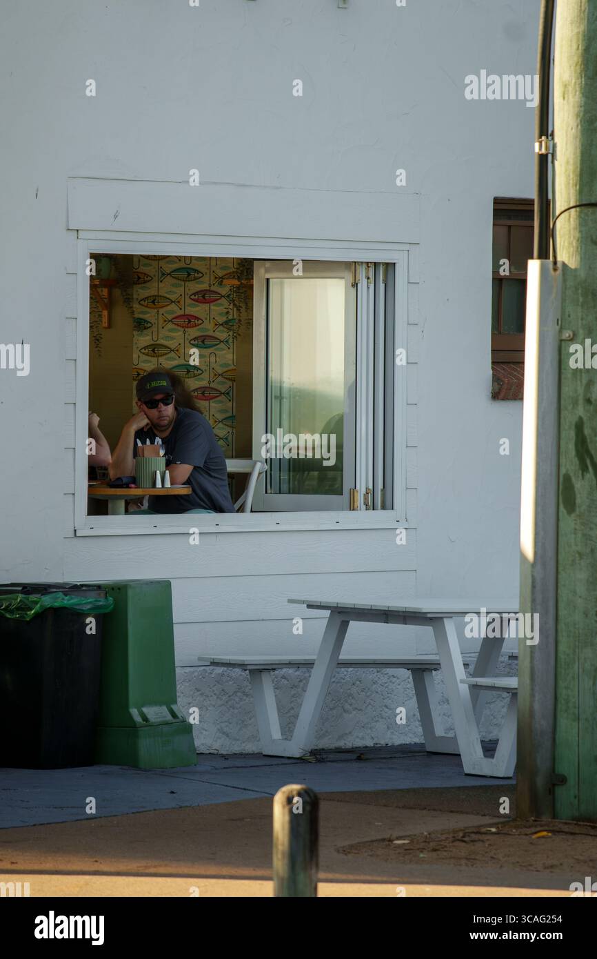Man wearing sunglasses sits table hi-res stock photography and images ...