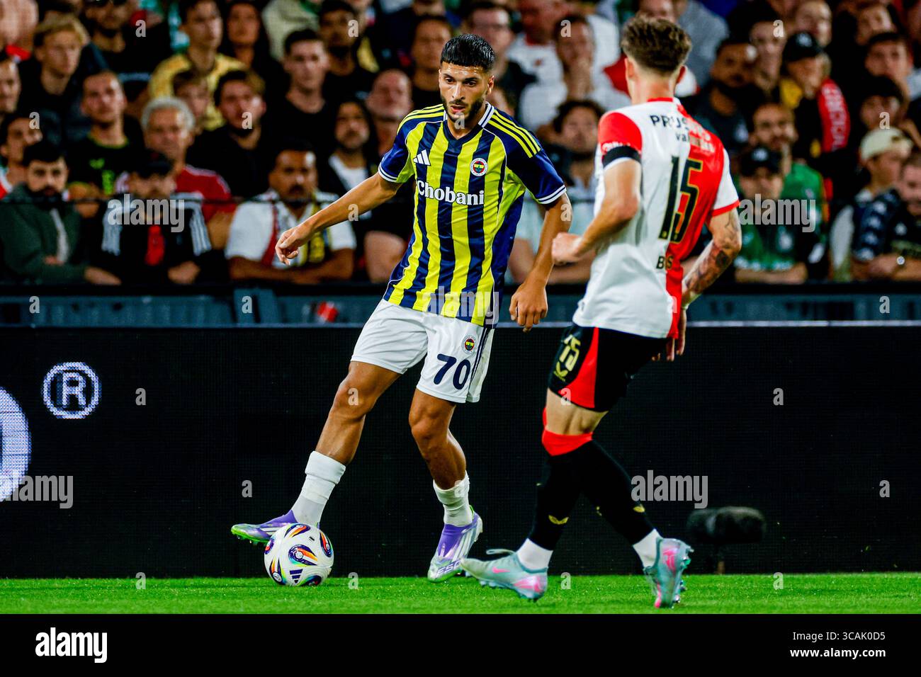 Oğuz Aydın of Fenerbahçe dribbles with the ball under pressure from Jordan Bos of Feyenoord during the UEFA Champions League, 3rd Qualifying Round, 2n Stock Photo