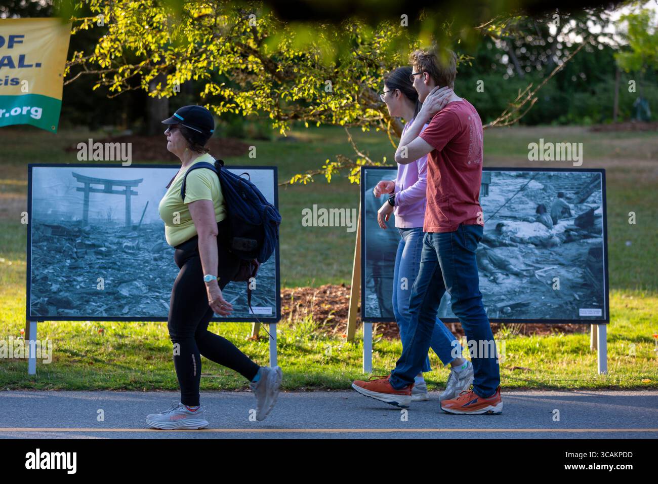 People pass photographs of the destruction of Hiroshima the Toro Nagashi Lantern Floating Ceremony at Green Lake in Seattle on Wednesday, August 6, 20 Stock Photo