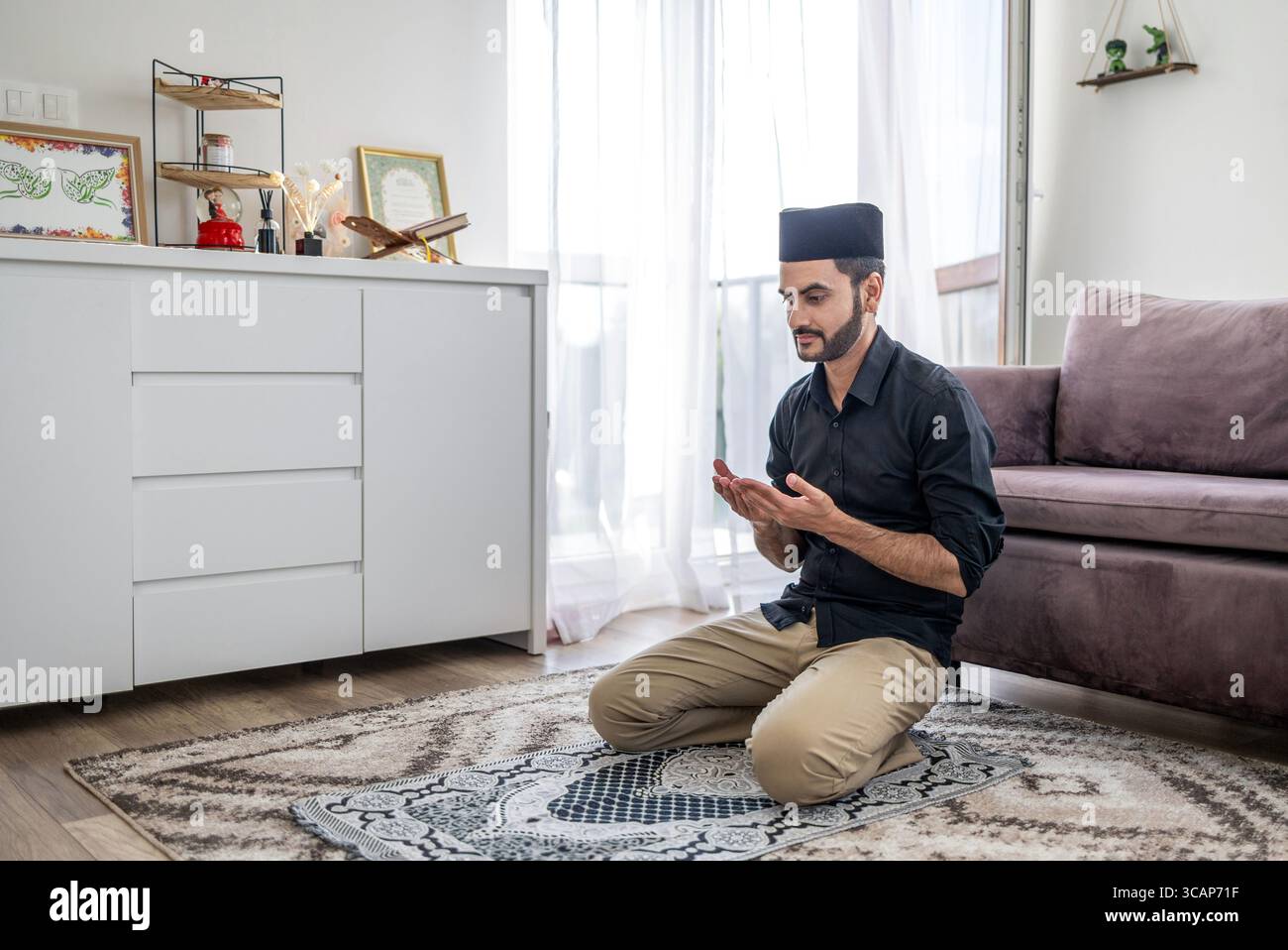 Muslim man praying at home Stock Photo