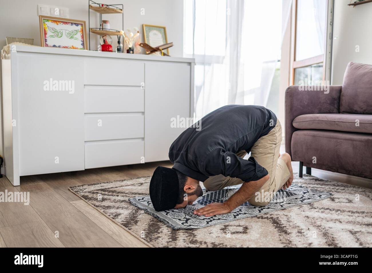 Muslim man praying at home Stock Photo