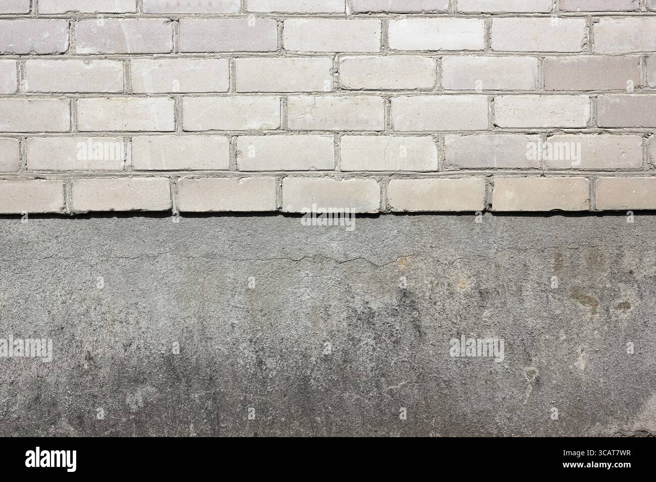 Sharp border between a white silicate bricks and plaster wall texture background Stock Photo