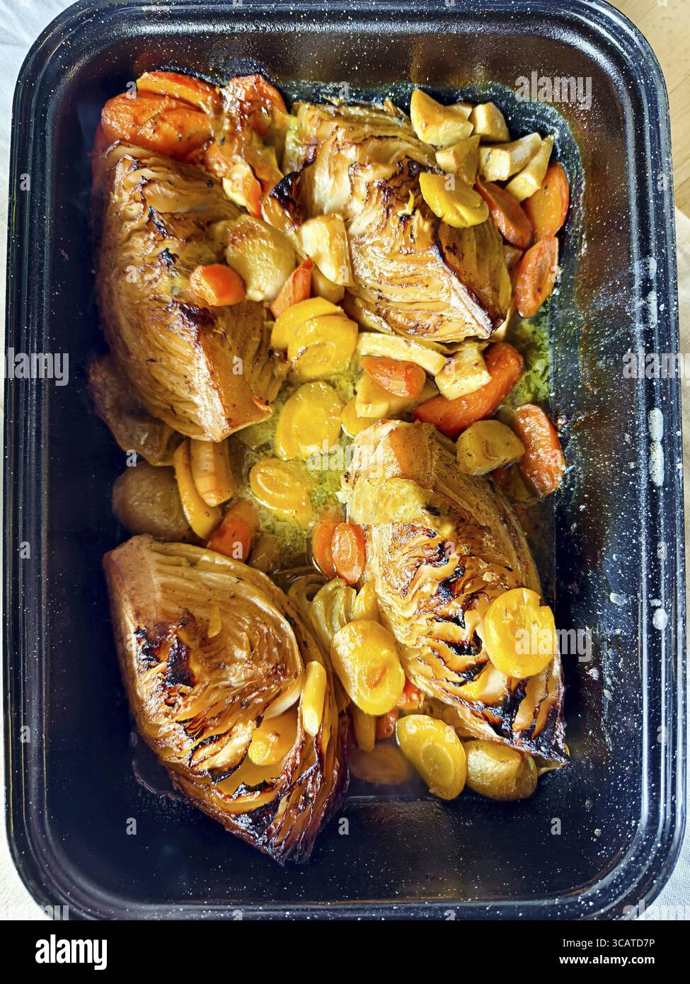 Various root vegetables baked golden brown in a rectangular baking tin Cooked roast cabbage Lower Austria Austria Stock Photo